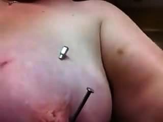 self piercing needle through her nipple